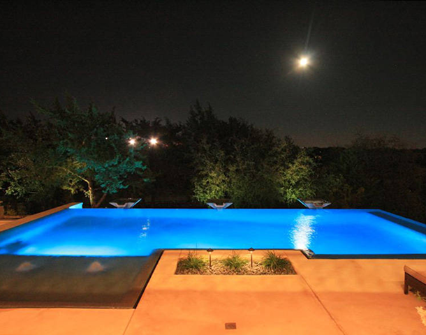 Nighttime poolside view under the moon