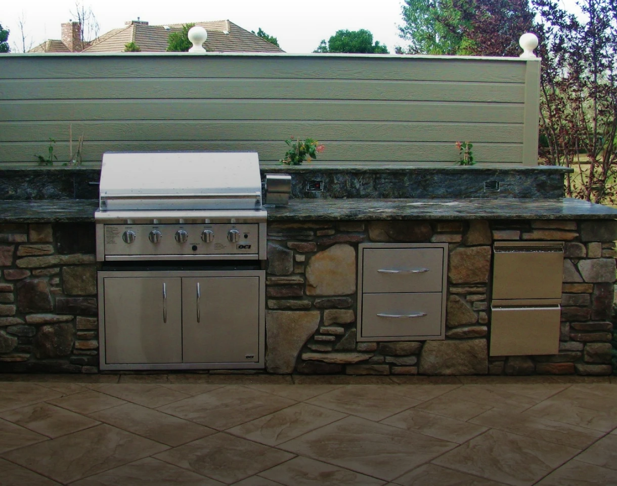 Modern backyard stone barbecue setup