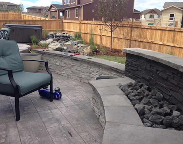 Patio with stone wall and seating area